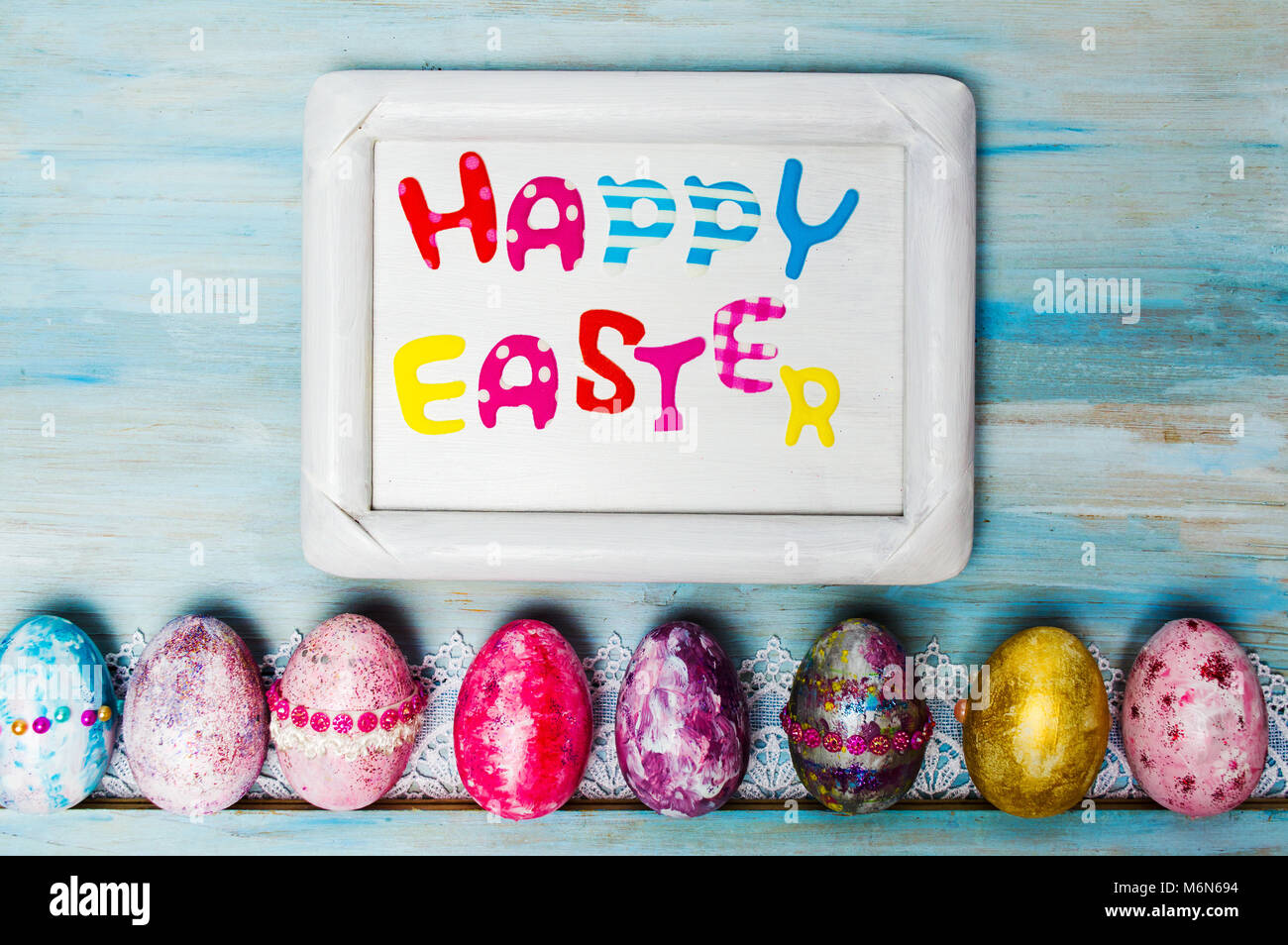 Happy Easter card in a frame with decorated eggs Stock Photo