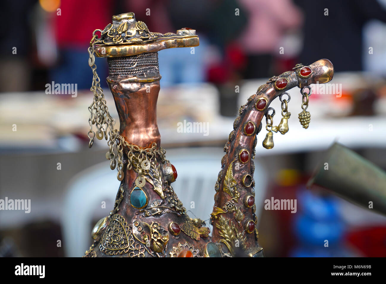 Oriental pitcher decorated with beads and chains Stock Photo