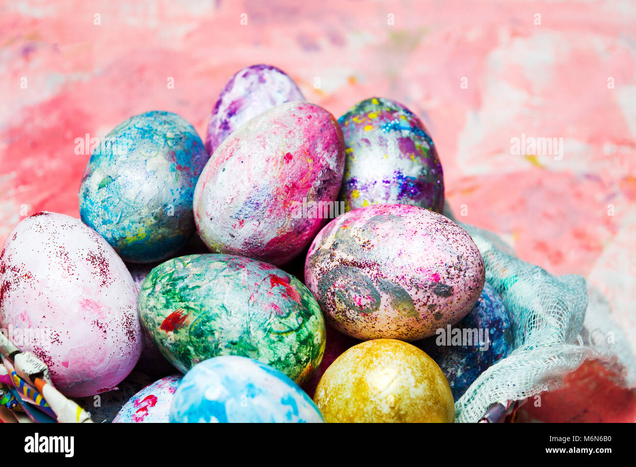 Painted Easter eggs in a bowl on pink background Stock Photo - Alamy