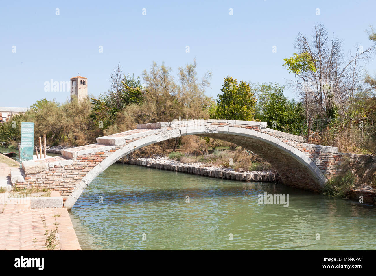 The historic Ponte del Diavalo, or Devil's Bridge, Torcello Island ,Venice , Italy, one of only two bridges in Venice that has no guard rails. Stock Photo