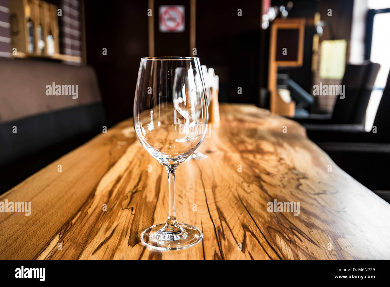 Empty wine glasses on slab table in restaurant Stock Photo