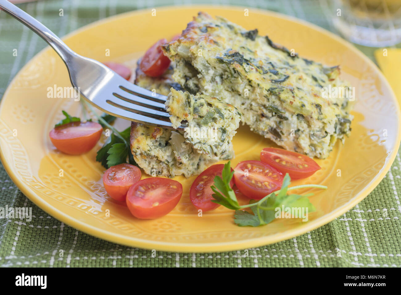 Crustless chard quiche made with eggs, chard, and cheeses, served with