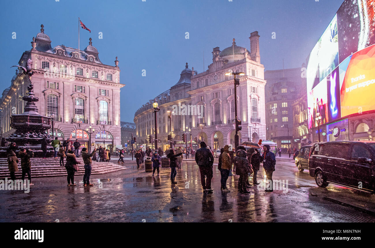 Piccadilly Circus After Snowy Winters Day at Night London UK Stock Photo