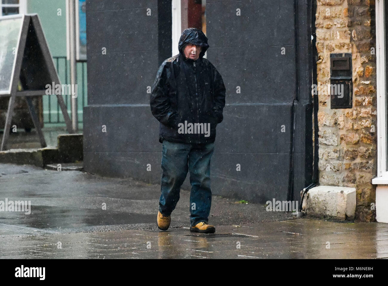 Bridport, Dorset, UK. 5th March 2018. UK Weather. A man walking in the