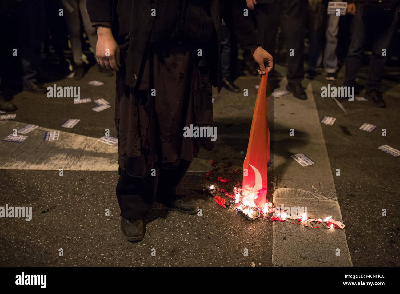 Athens, Greece. 05 March 2018, : A supporter of the Greek far-right party 'Golden Dawn' burns a Turkish flag during a demonstration against the Turkis policy. Amongst others, they protest against the arrest of two Greek soldiers, who crossed the border to Turkey on 1 March and stated that they got lost. A Turkish court put them into custody on suspicion of attempted military espionage on 2 March. Photo: Socrates Baltagiannis/dpa Credit: dpa picture alliance/Alamy Live News Stock Photo