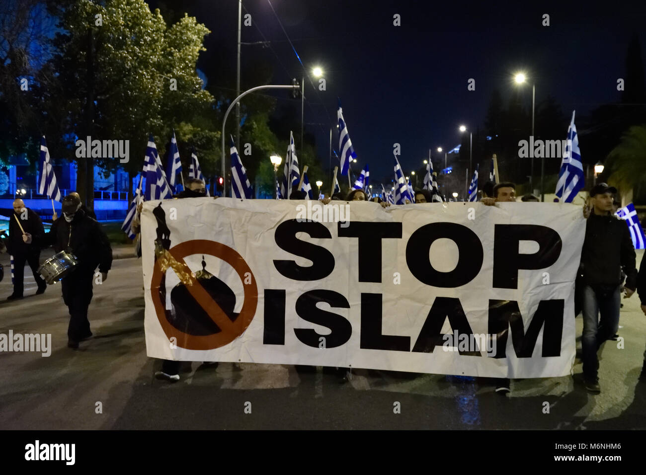 Athens, Greece, 5th March, 2018. Golden Dawn supporters march holding a banner that reads 'Stop Islam' to protest against the arrest of two Greek army officers while patrolling the Greek-Turkish border by Turkish forces in Athens, Greece. Credit: Nicolas Koutsokostas/Alamy Live News. Stock Photo