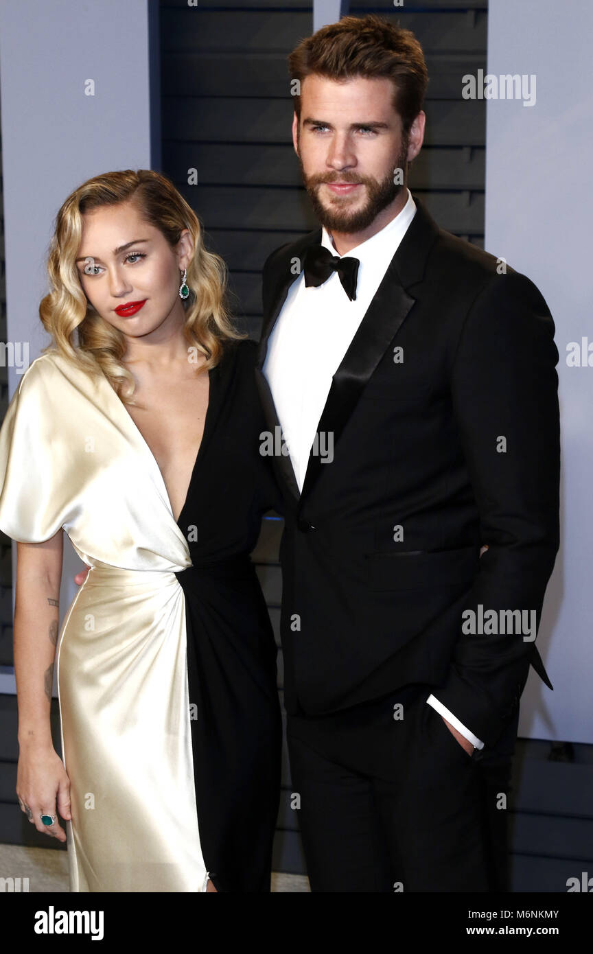 Miley Cyrus and Liam Hemsworth attending the 2018 Vanity Fair Oscar Party hosted by Radhika Jones at Wallis Annenberg Center for the Performing Arts on March 4, 2018 in Beverly Hills, California. | usage worldwide Stock Photo