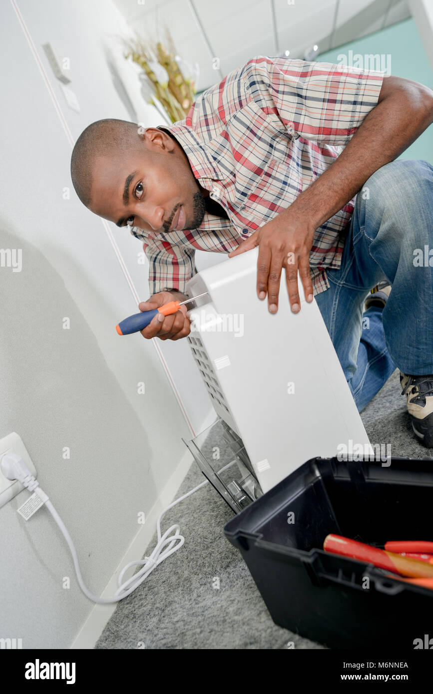 Man working on electrical appliance Stock Photo