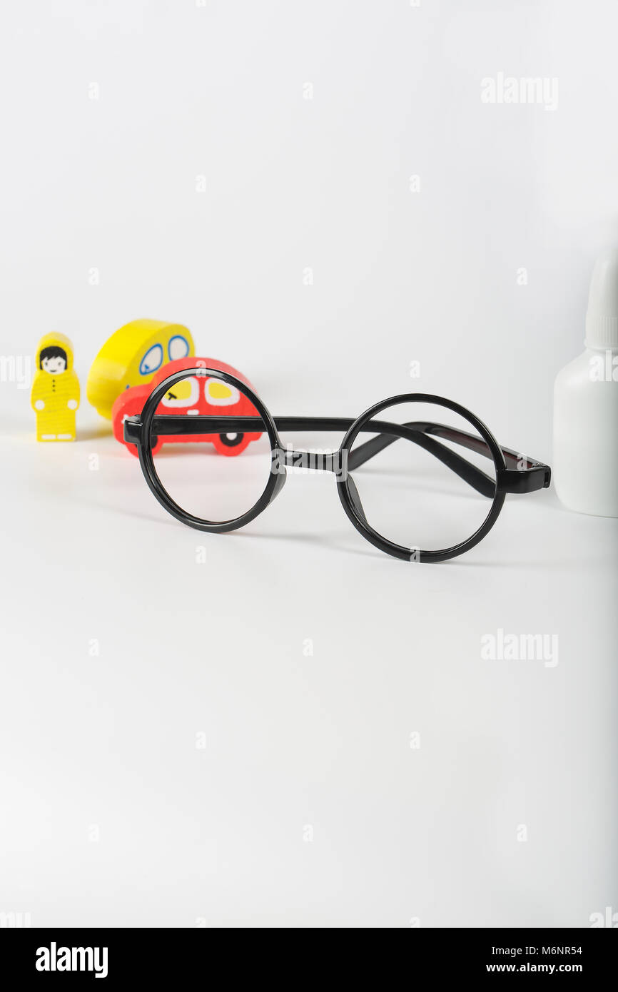 Eyeglasses,mini cars,prescription,wooden made driver on a gray surface Stock Photo Alamy