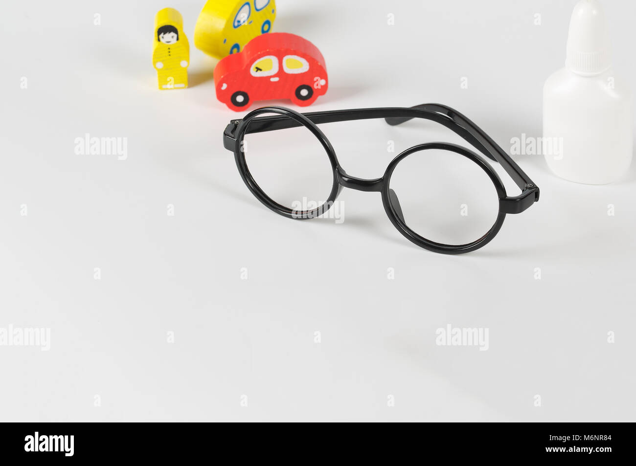 Eyeglasses,mini cars,prescription,wooden made driver on a gray surface Stock Photo Alamy