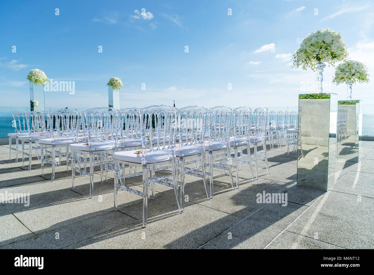Wedding venue decorated with mirror box flowers, floral, ghost chairs, modern style made from acrylic in clear Stock Photo