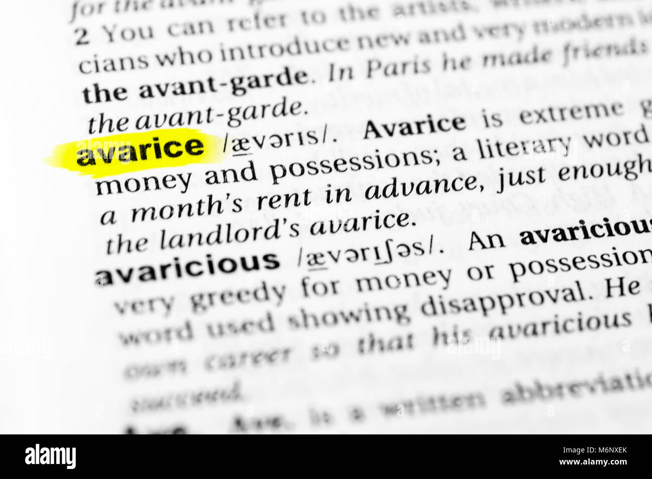 Highlighted English word 'avarice' and its definition in the dictionary. Stock Photo