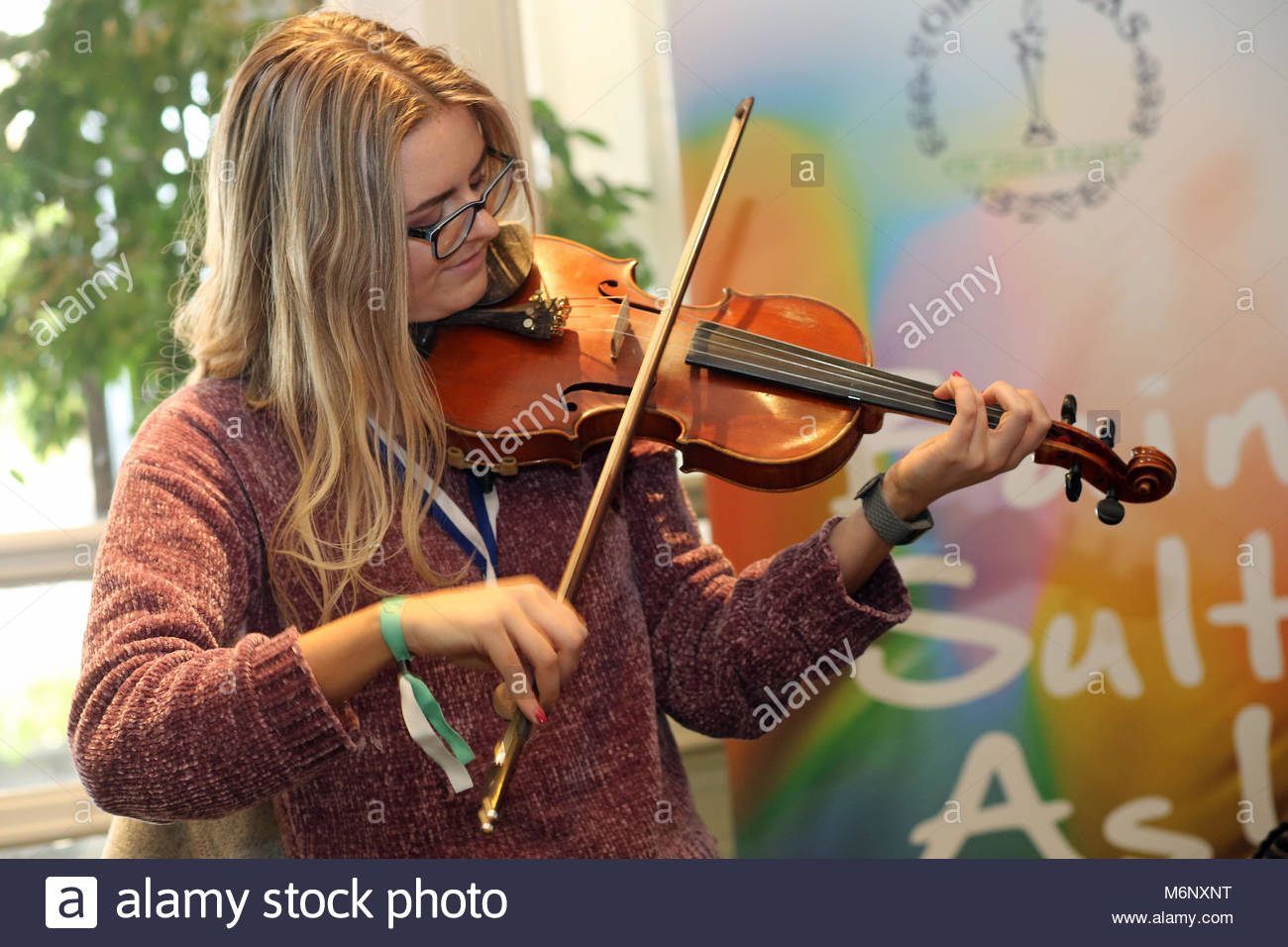 A participant at the Irish language and music festival in Killarney plays a tune on the fiddle. Stock Photo