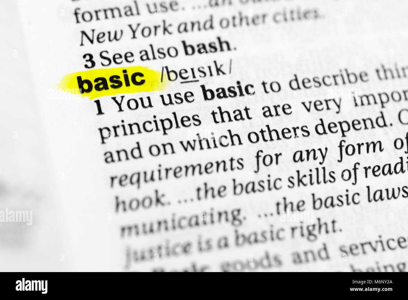 Highlighted English word 'basic' and its definition in the dictionary. Stock Photo