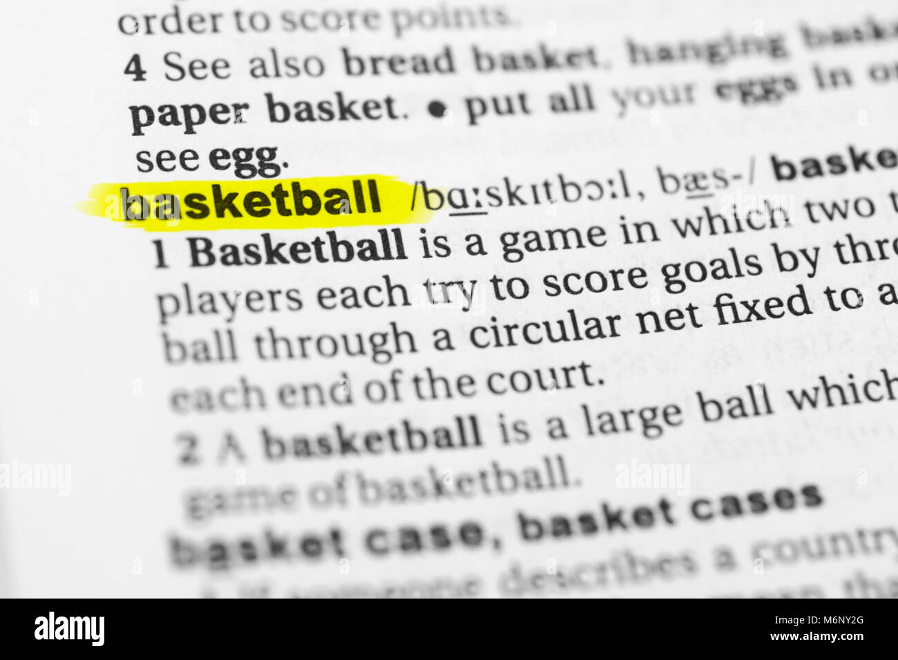 Highlighted English word 'basketball' and its definition in the dictionary. Stock Photo