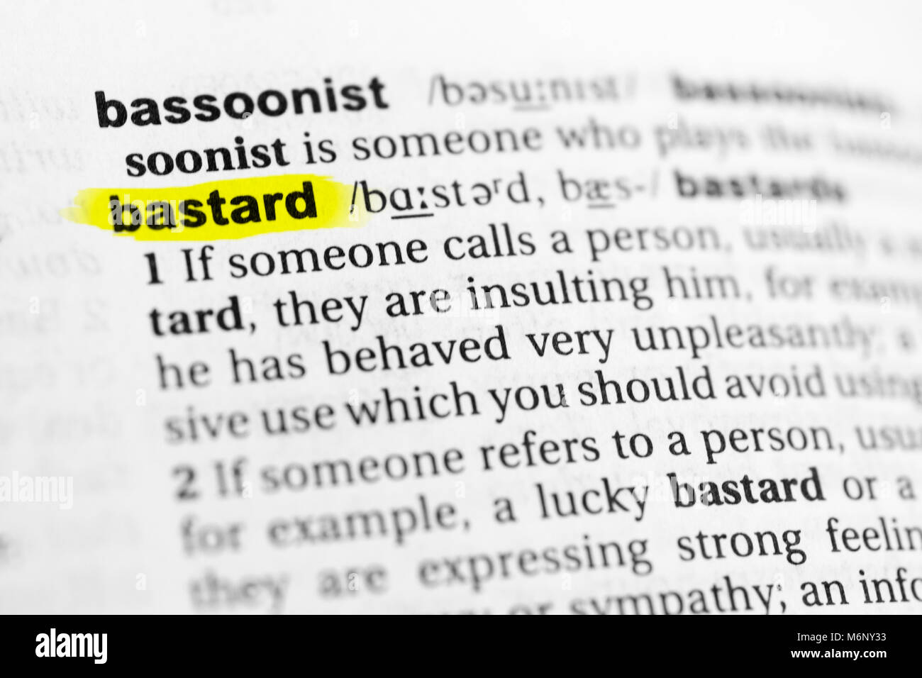 Highlighted English word 'bastard' and its definition in the dictionary. Stock Photo