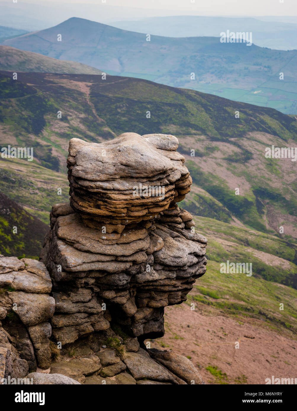 Weathered  gritstones of Upper Tor looking over Grindsbrook towards Lose Hill on Kinder Scout in the Derbyshire Peak District Stock Photo