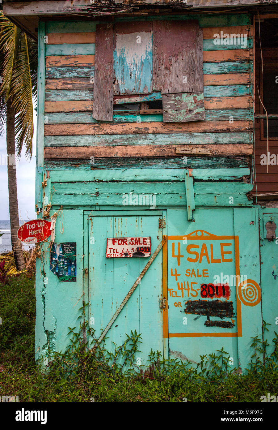 Dilapidated beach side property for sale on the Caribbean island of Dominica in the West Indies Stock Photo