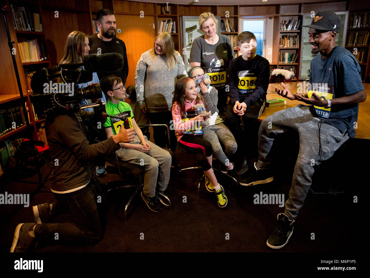 Sir Mo Farah surprises families from the North West who have been chosen to take part in the Simplyhealth Great Manchester Run Family Challenge. PRESS ASSOCIATION. Issue date: Monday March 5, 2018. The Parry family, from Prestwich in Greater Manchester and the Wilkinson family from Bolton travelled to South-East London where they met Great Britain’s most successful distance runner. Photo credit should read: Isabel Infantes/PA Wire Stock Photo