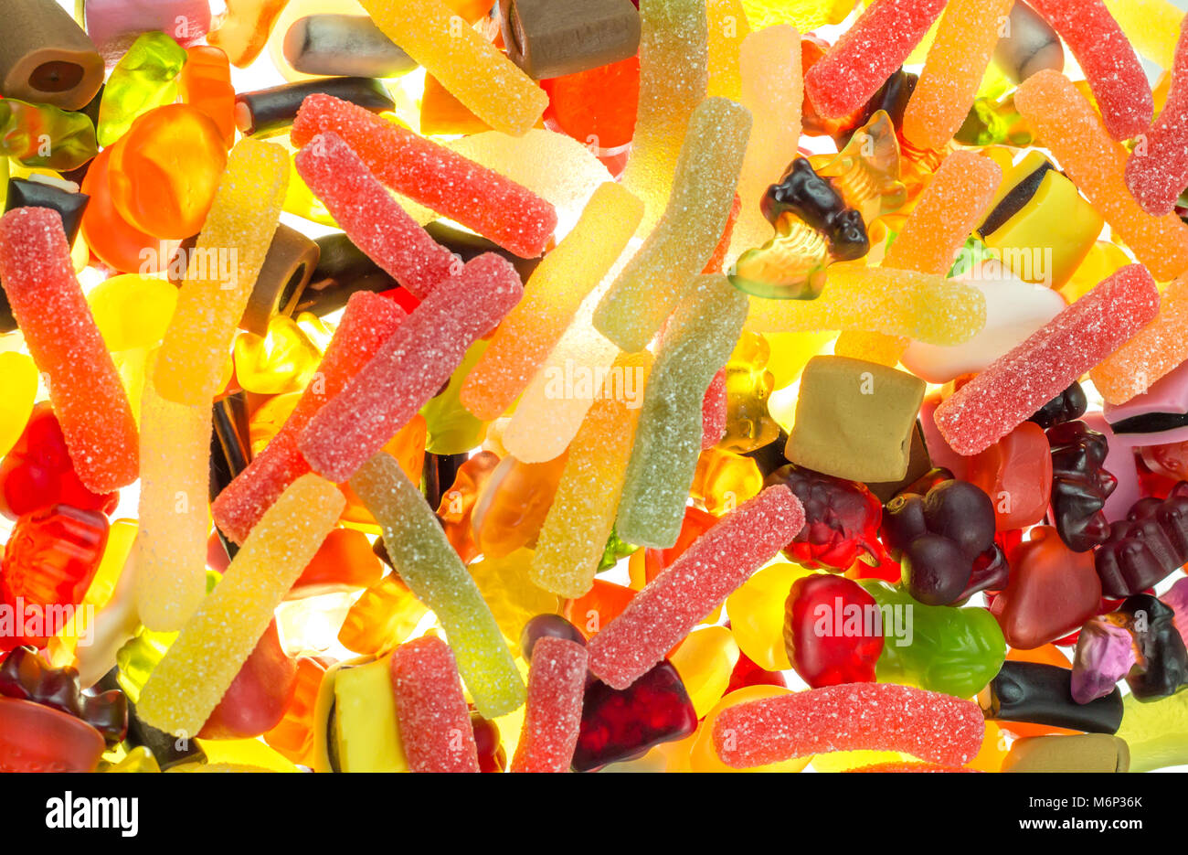 colorful fruit gums mix bright translucent on illuminate underground Haribo sweets Stock Photo