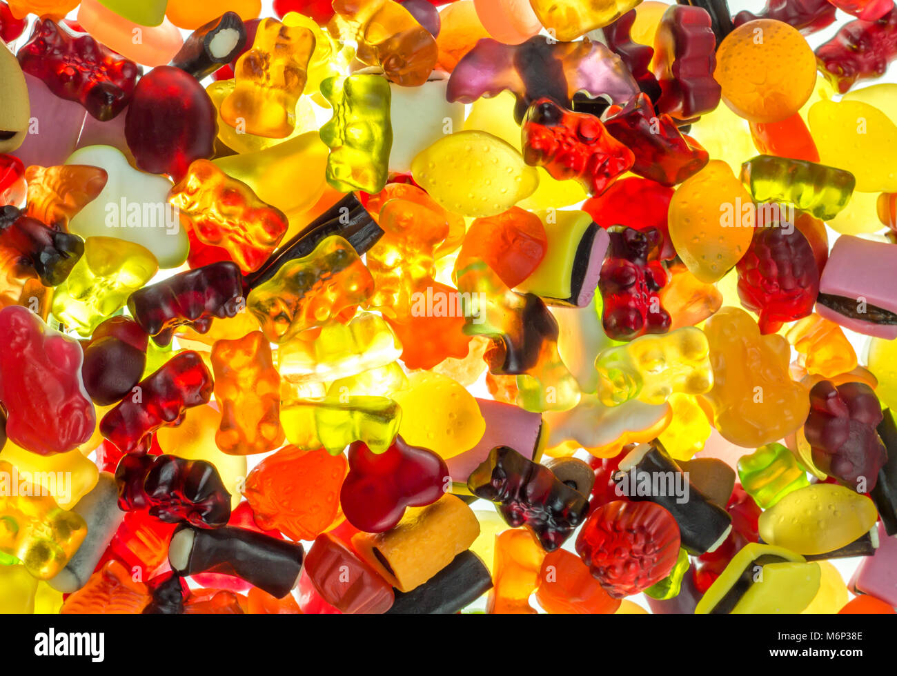 colorful fruit gums mix bright translucent on illuminate underground Haribo sweets Stock Photo