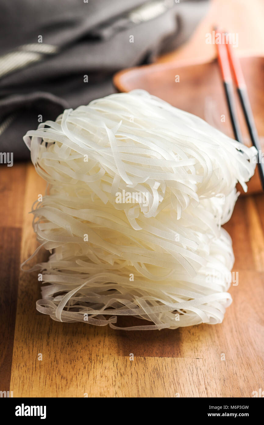 Dried rice noodles on wooden table Stock Photo Alamy