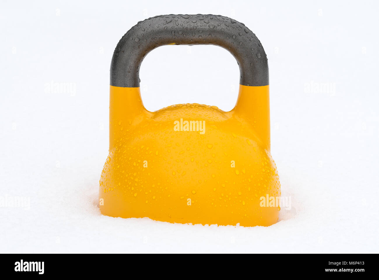 Yellow weight training kettlebell in the snow. Potential use as offseason /  winter training concept Stock Photo - Alamy