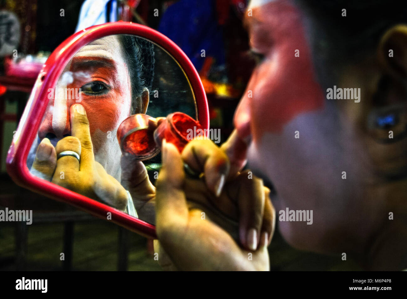 Chinese opera actor making up on backstage during a tour on Thailand, Chinatown, Bangkok, Thailand. Stock Photo