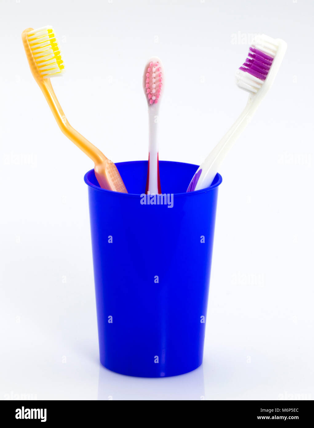 Toothbrushes in glass isolated on white background Stock Photo - Alamy