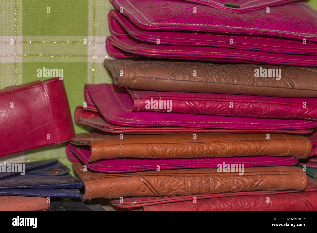 Close up detail of a stack of colourful handmade leather purses for sale in the souk artisan in Fes, Morocco. Stock Photo