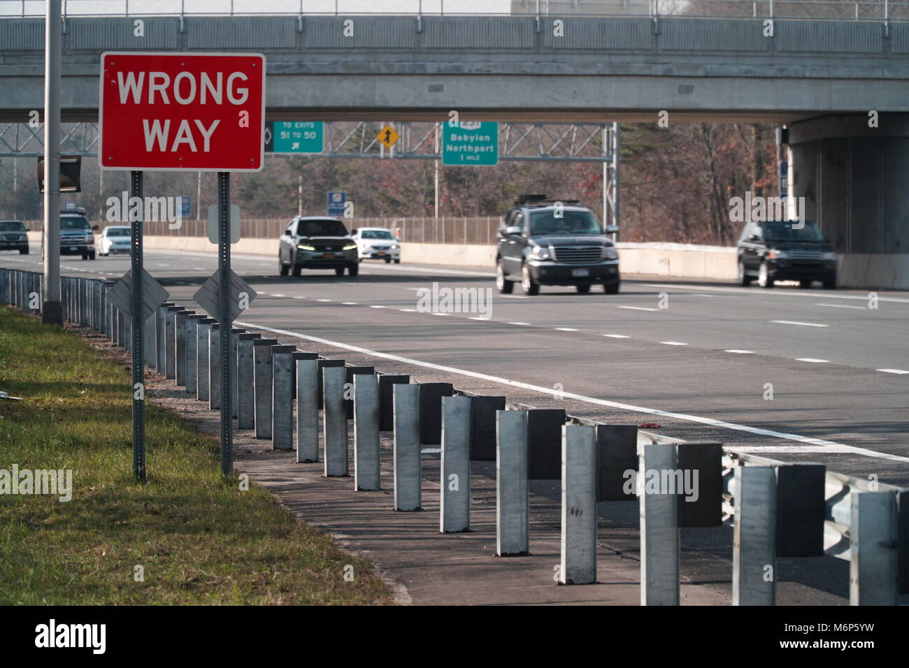 Wrong Way caution safety sign posted along a major interstate highway