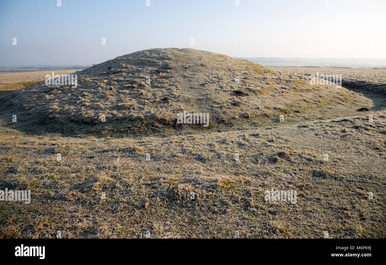 Bronze Age bowl barrow on Windmill Hill, a Neolithic causewayed enclosure, near Avebury, Wiltshire, England, UK Stock Photo