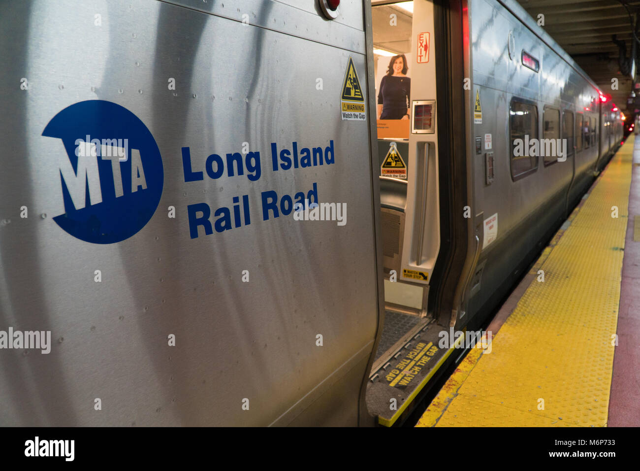 New York City, Circa 2017: MTA Long Island Railroad train car open door in Penn Station Manhattan waiting for commuter passengers to board during even Stock Photo
