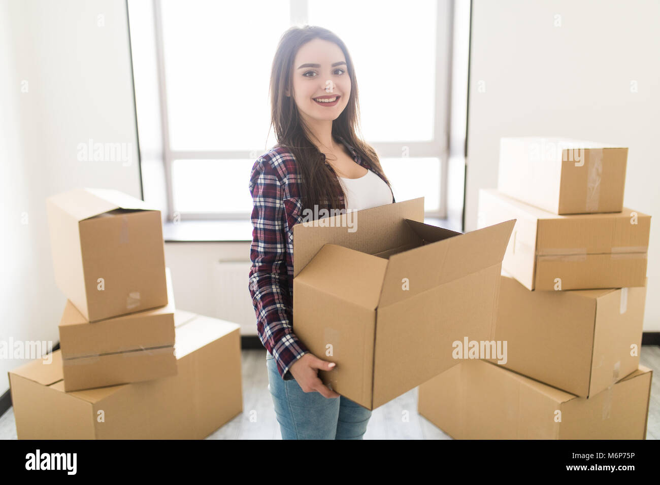 Woman stacking cardboard boxes hi-res stock photography and images - Alamy