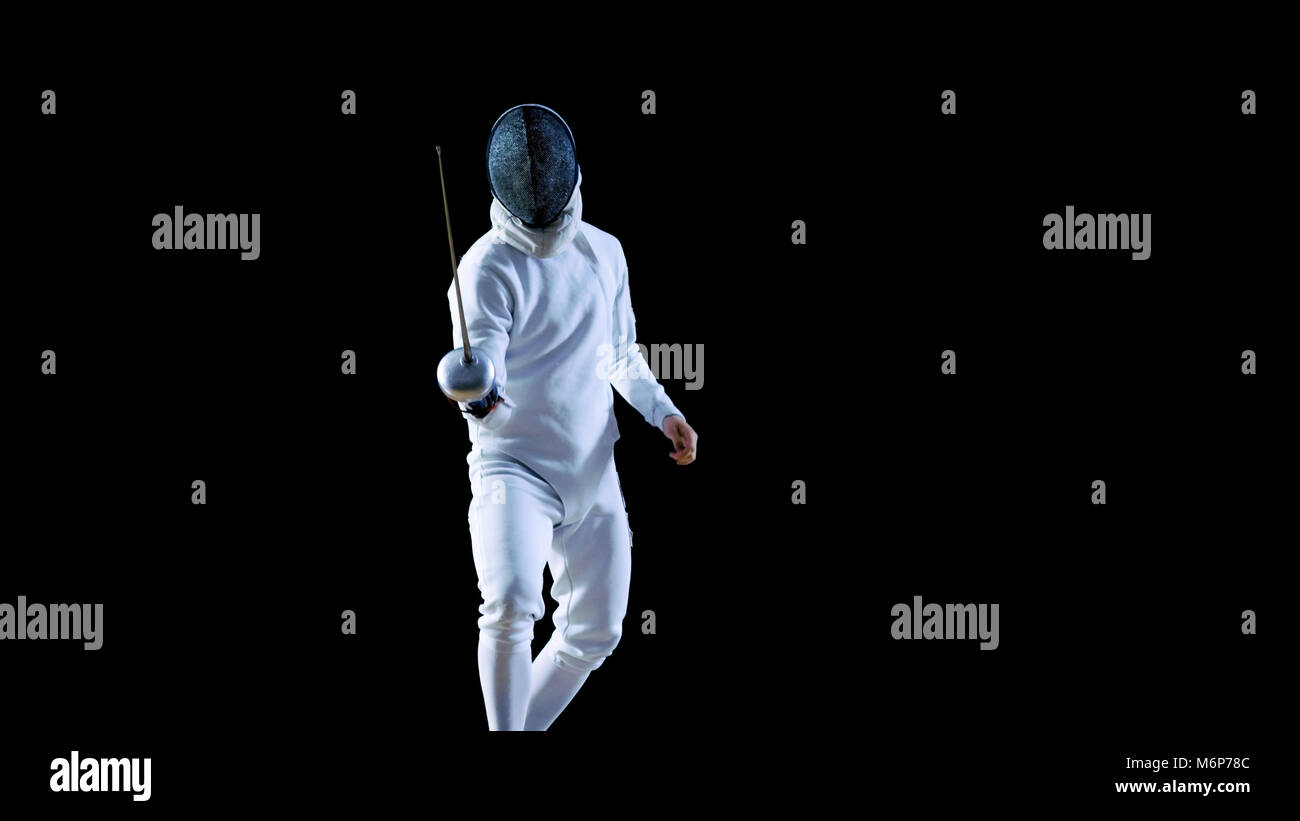 Portrait Shot of a Fully Equipped Skilled Fencer Training with a Foil. He Practices Attack, defense,  Leap, Thrust and Lunge. Stock Photo