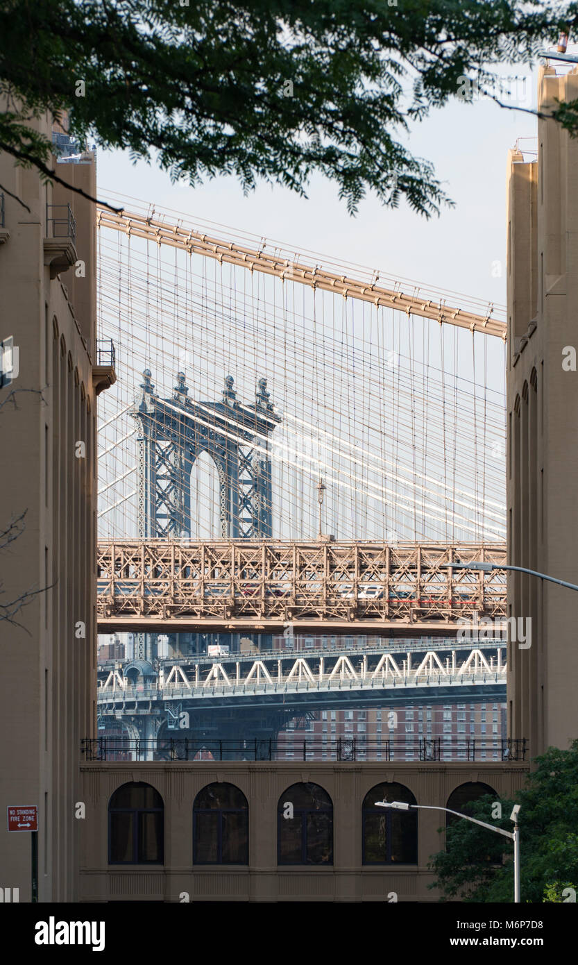 Manhattan and Brooklyn bridges vertically framed view between two New