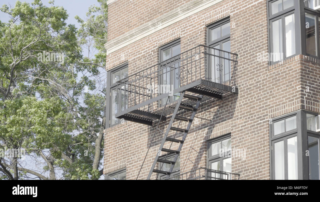 Exterior establishing photo of generic brick facade apartment building ...