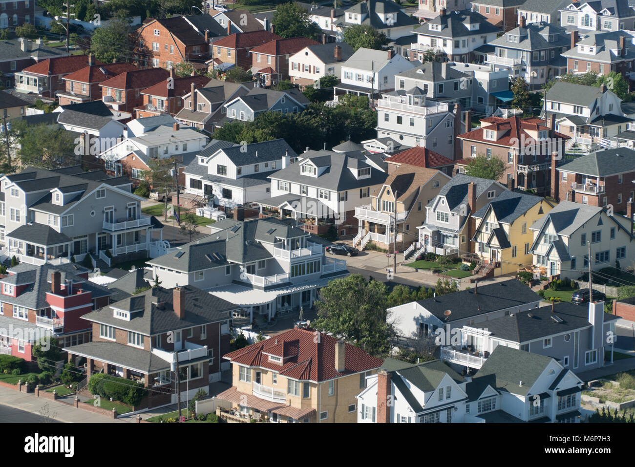 Aerial birds eye view of expensive ocean side real estate houses on bright summer day. Neighborhood of luxury beach front homes Stock Photo