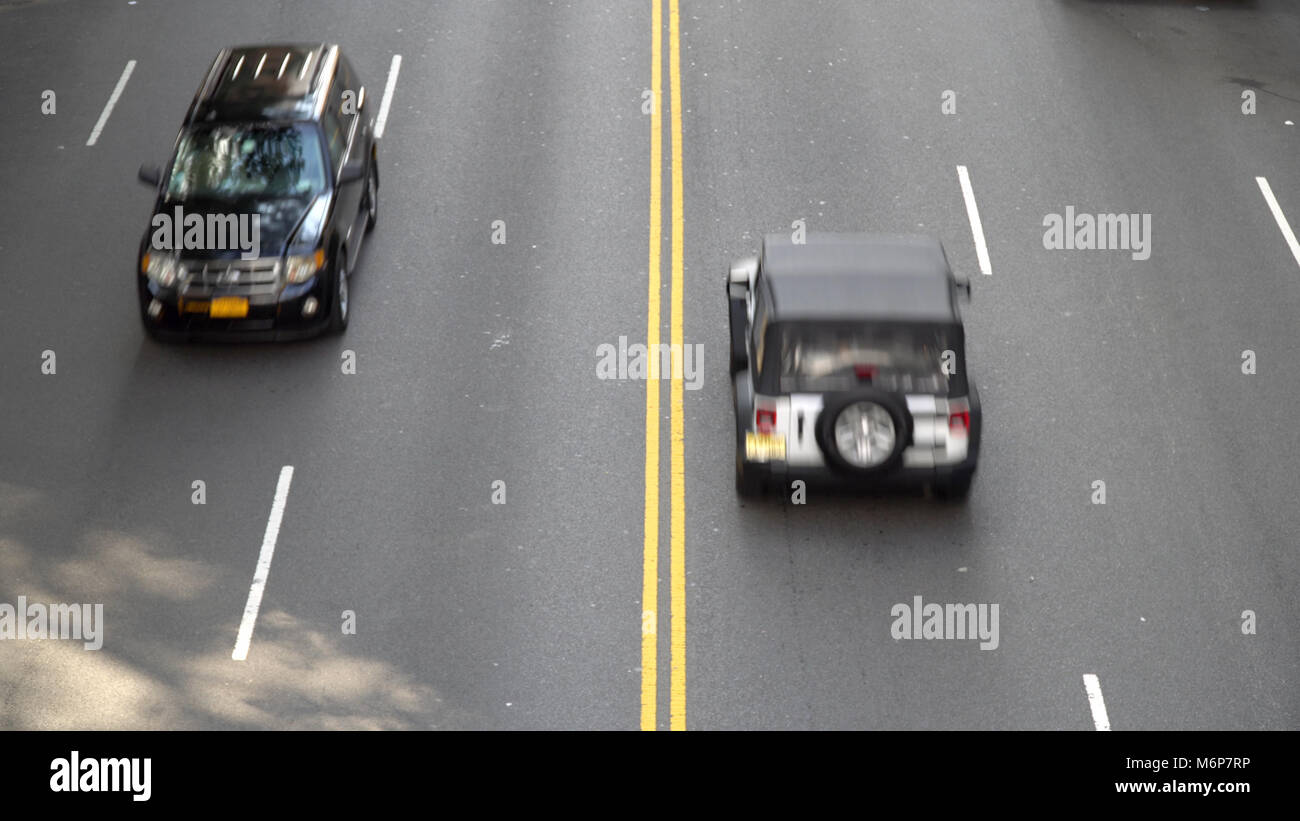 Overhead aerial view of street traffic motiion blur cars driving