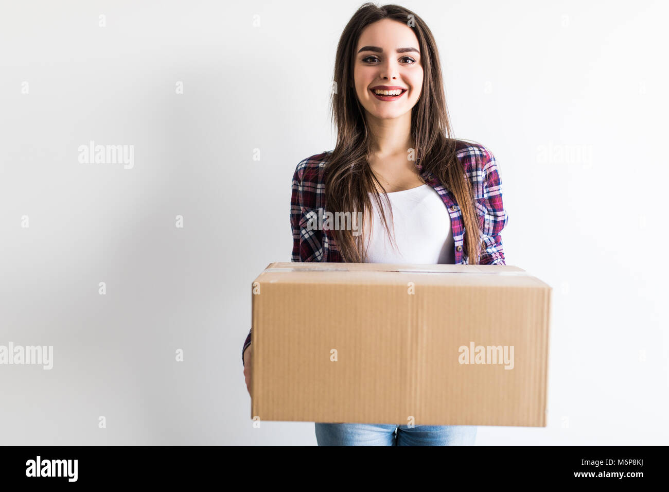 Woman carrying moving boxes. Young woman moving house to new home ...