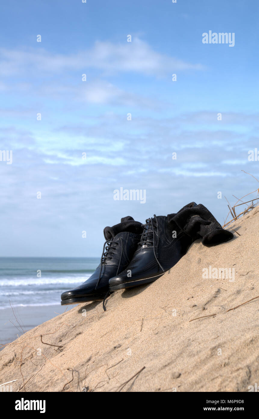 Dress shoes with sock on the beach. Business concept Stock Photo