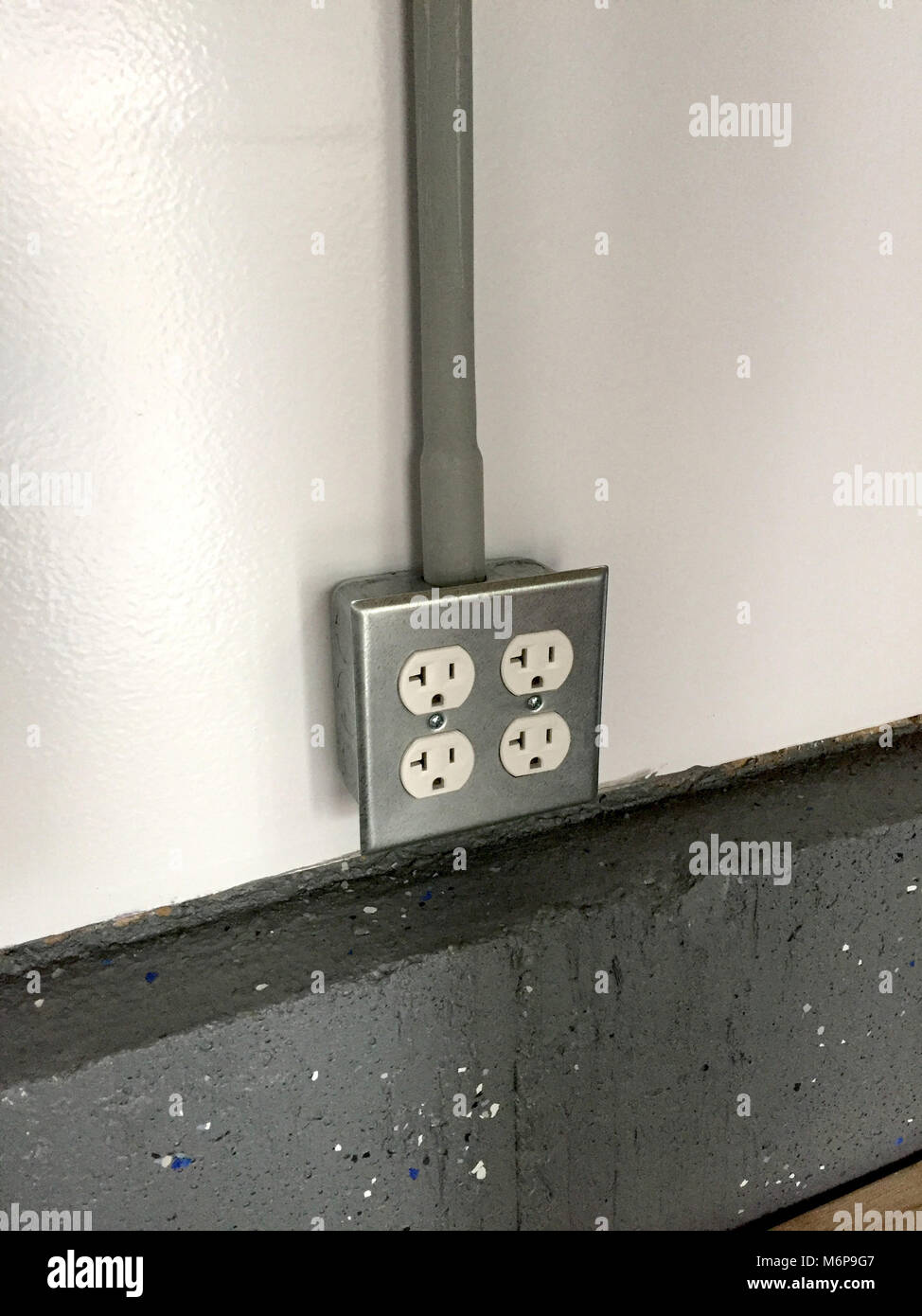 2 Gang Power Outlet Receptacle Box Mounted On A White Wall Over