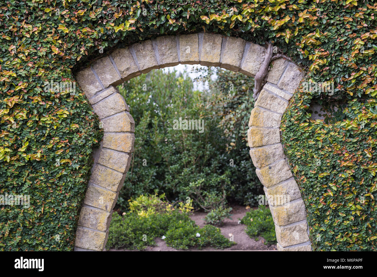 A stone archway on the walking path in Hamilton Gardens, New Zealand Stock Photo