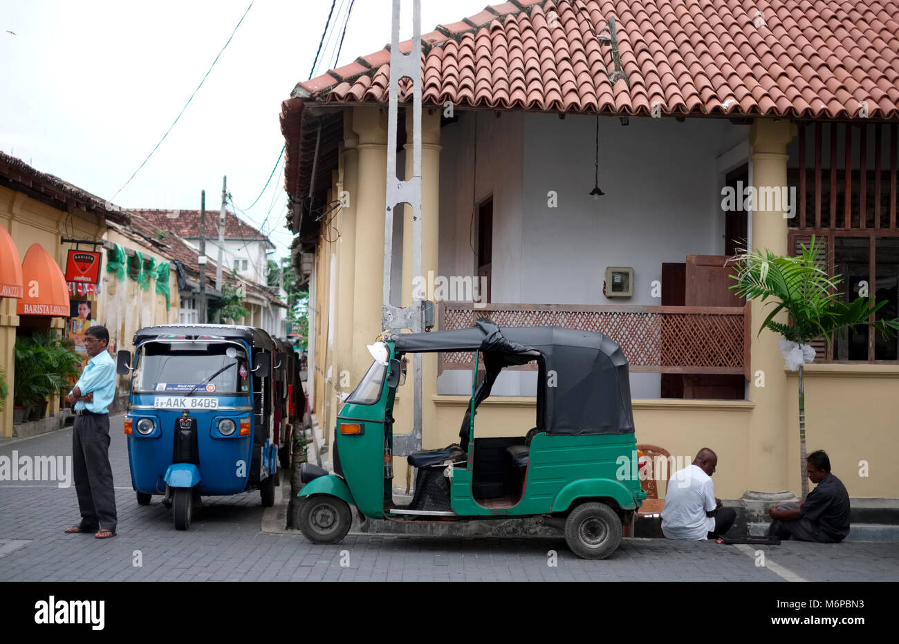 Two men play a board game next to a tuk tuk taxi in Galle in Sri Lanka Stock Photo Alamy