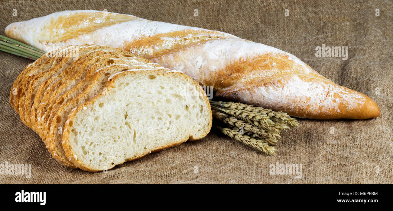 sliced white bread, baguette and wheat ears on burlap Stock Photo Alamy
