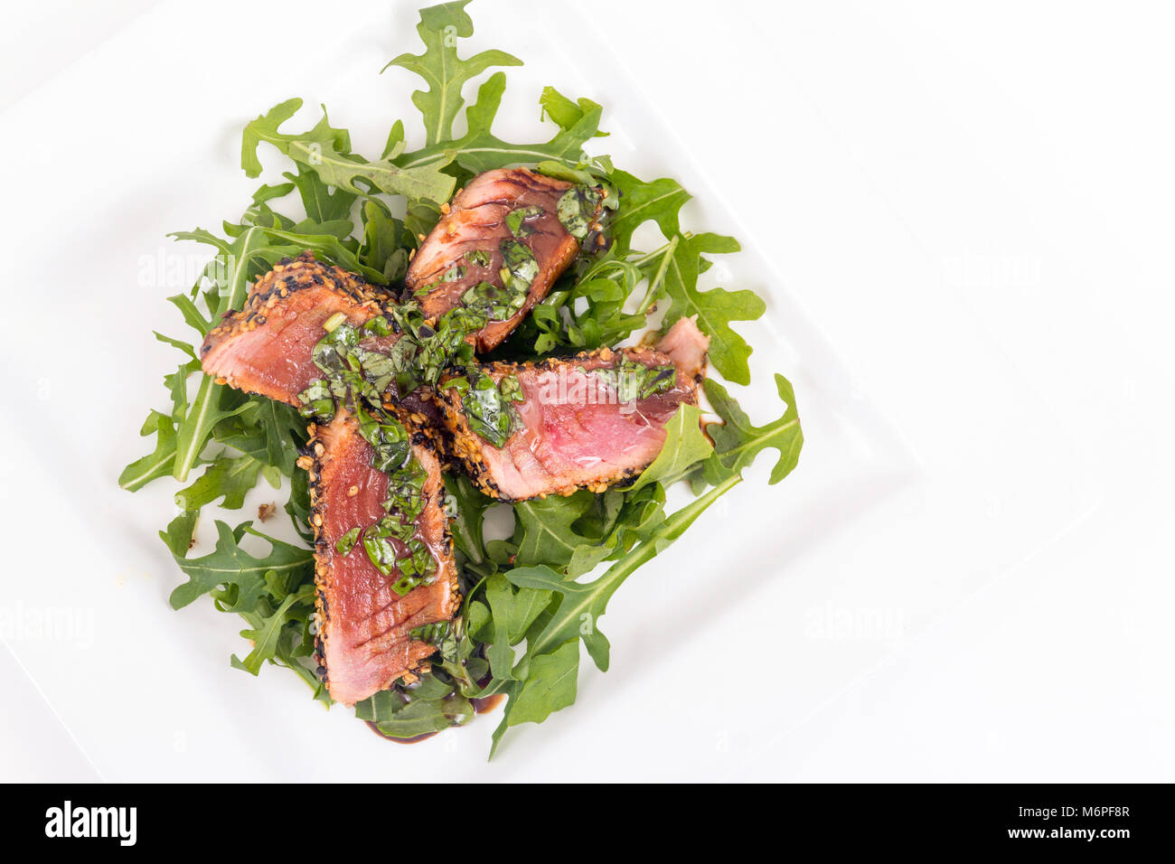 tuna tataki sesame crust appetizer plate over wood backgroung Stock