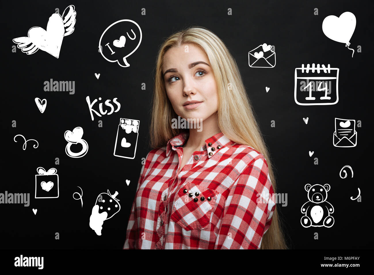 Romantic young person looking thoughtful while dreaming about her beloved man Stock Photo