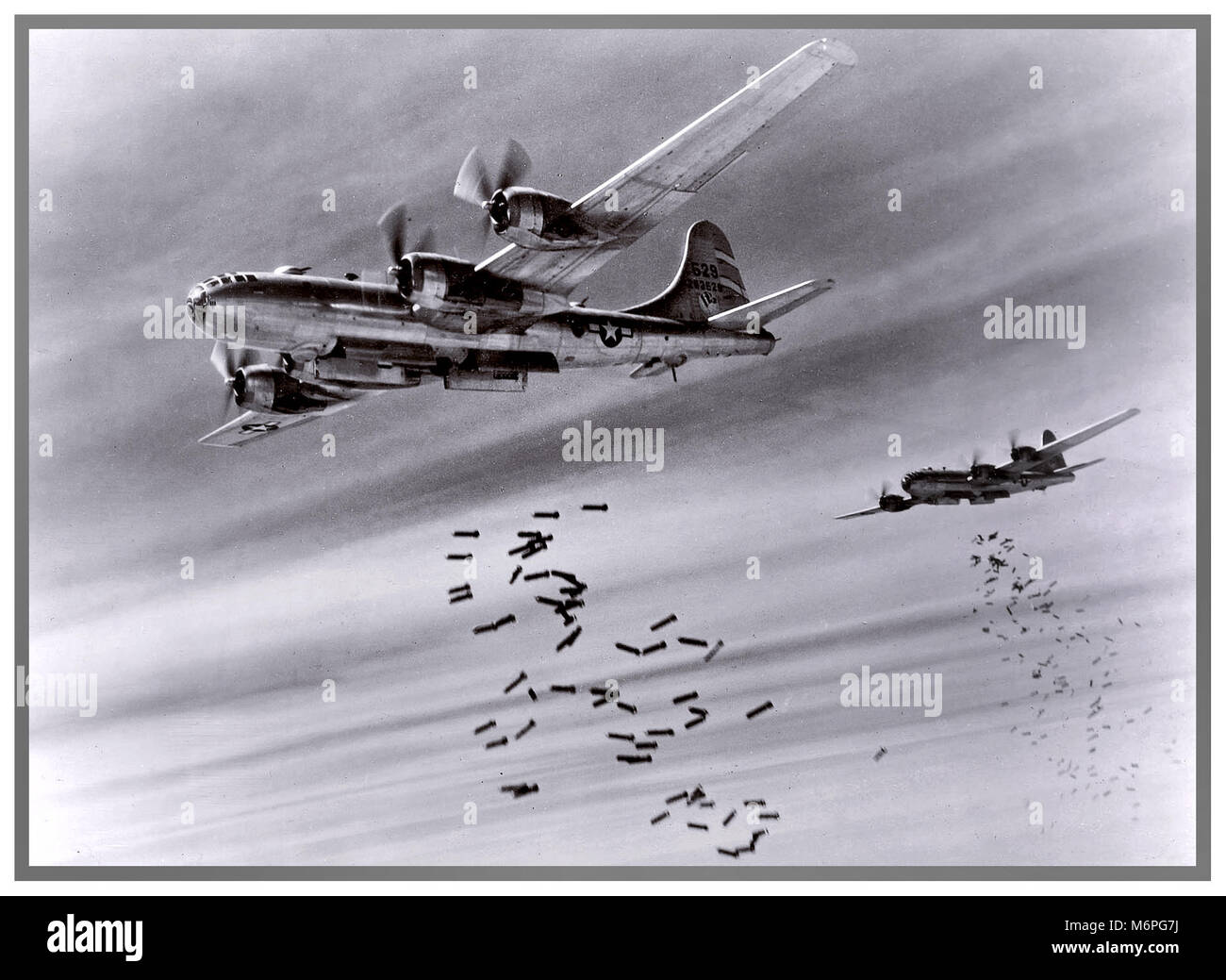 WW2 USAF Boeing B-29s drop bombs over Rangoon, Burma. 1942 Attack against the invading forces of The Imperial Army of Japan .Nearest aircraft is B-29-25-BA of the 468th Bomb Group. Stock Photo