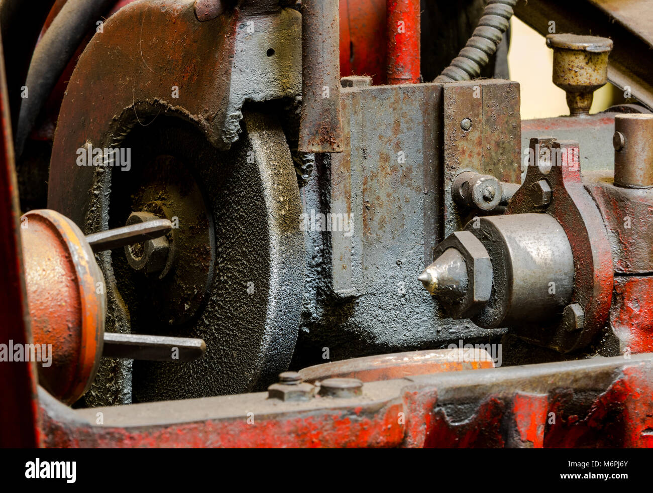 Vintage antique automotive machine shop dirty piston grinding machine stone and centering chuck Stock Photo