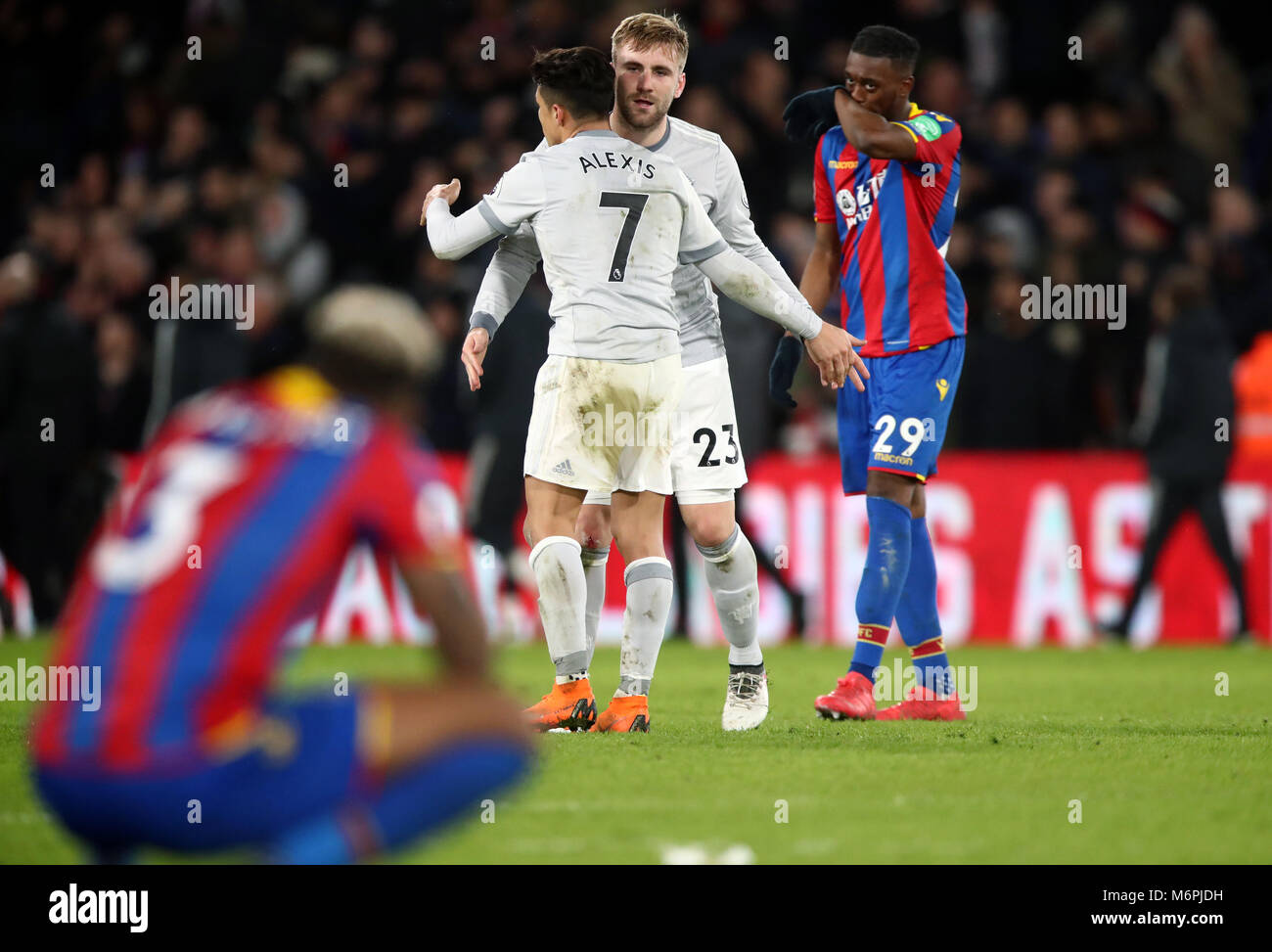 Manchester United's Alexis Sanchez and Luke Shaw celebrate at the final whistle during the Premier League match at Selhurst Park, London. Stock Photo